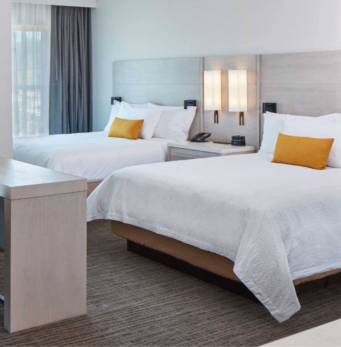 A hotel guest bedroom with two queen beds