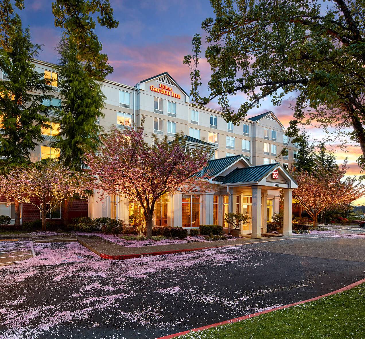 An exterior view of the Hilton Garden Inn in the springtime