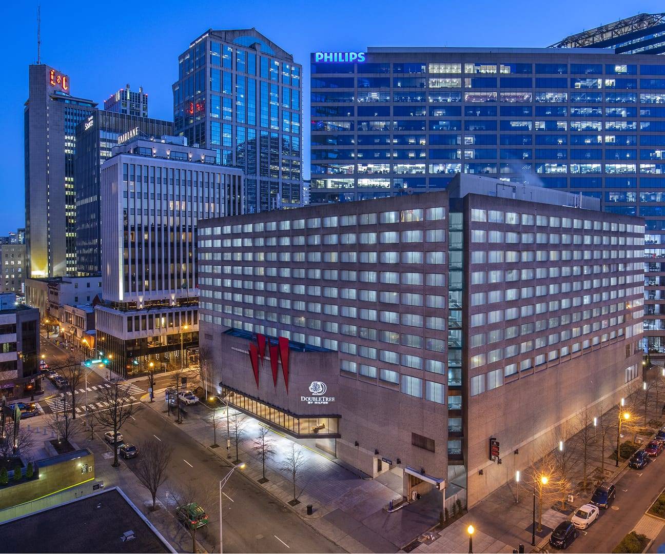 An exterior view of Double Tree by Hilton with the surrounding cityscape